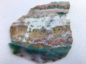 Hyper-heterogeneous slab from Vein 1/2 with ultra-rare vivid translucent blues, ~6.5in wide, Back. Cut by Owyhee Gemstones, Idaho.