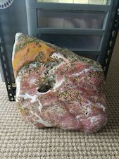 The large boulder size specimen that produced the preceding sculpure, and many slabs/faced rough specimens. Estimated weight greater than 65lbs, size a couple of feet (~24in length). An amazing Ocean Jasper specimen photo from Ashley Rosenn at Northwoods Hobbyist